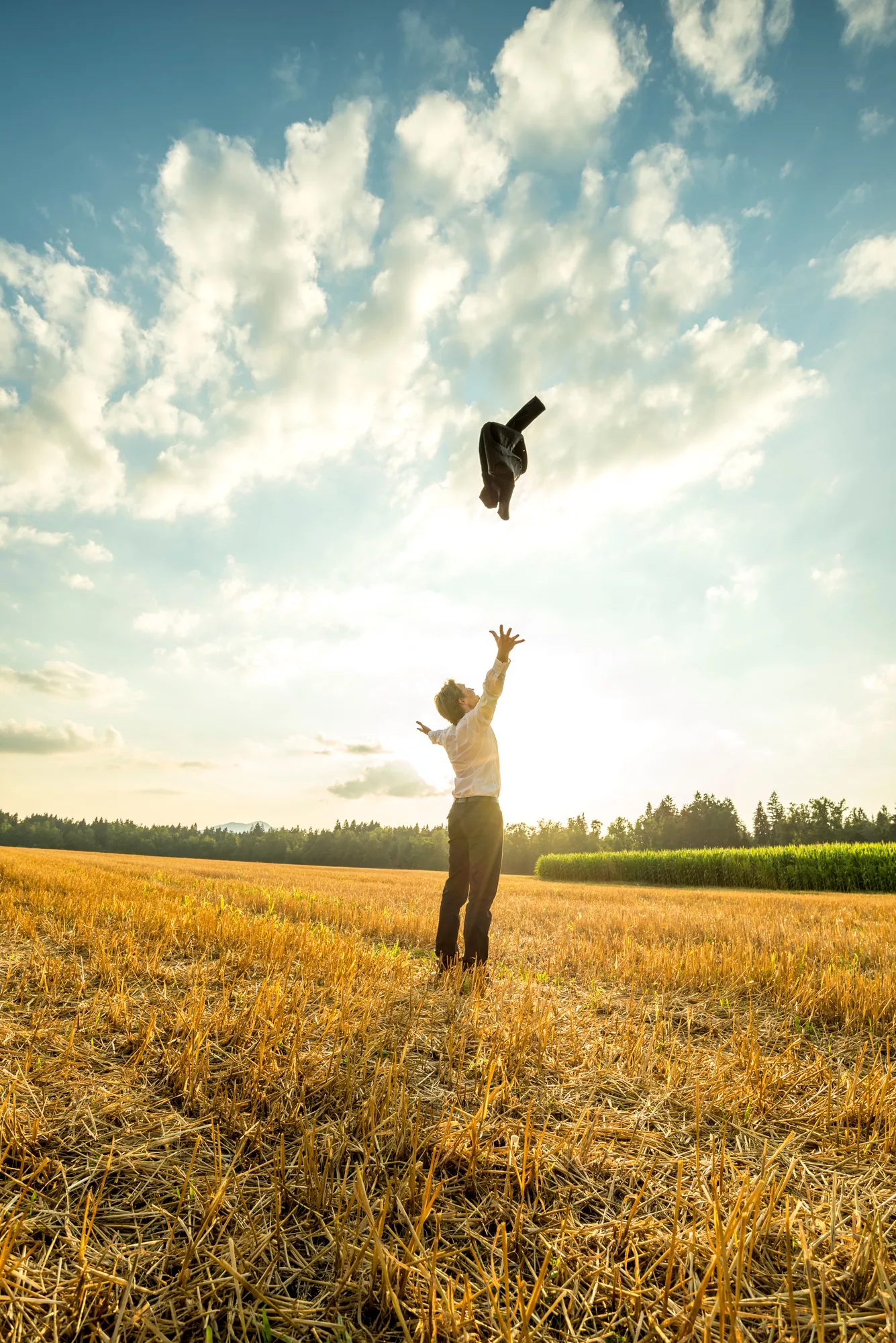 Businessman Throwing Coat in the Air at the Field